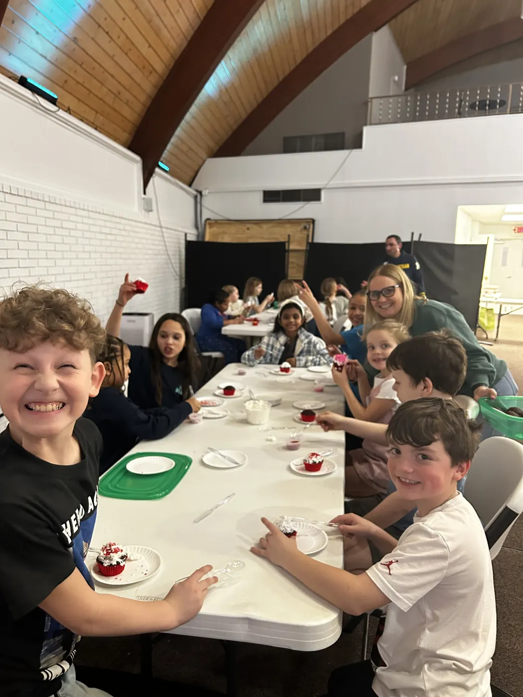 Kids smiling around a table during a kids night