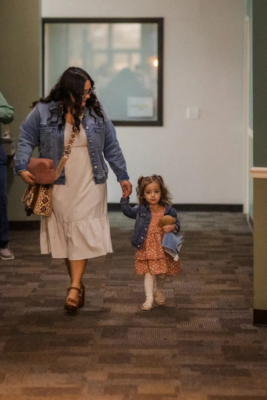 A mom and her daughter walking into church together
